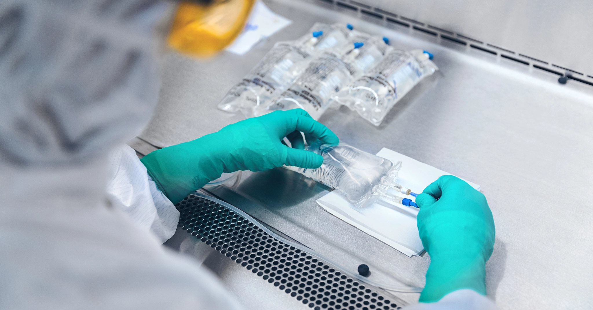 Pharmacist in laboratory holding an IV bag