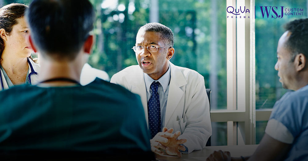 Four health professionals discuss at a table